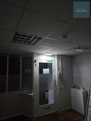 "Fire exit" sign with an emergency light fixture directly above