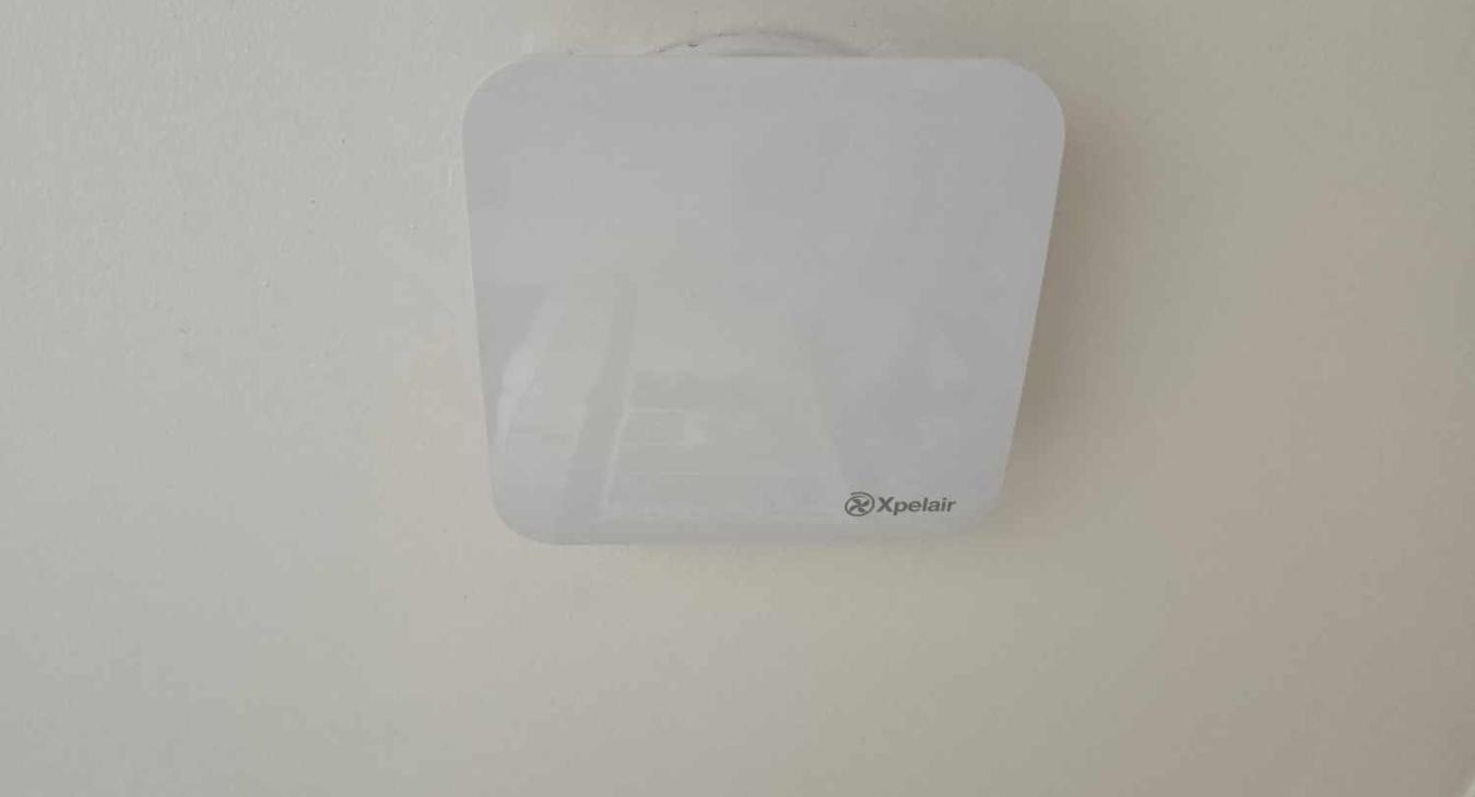 Image of a white bathroom extractor fan installed on the ceiling